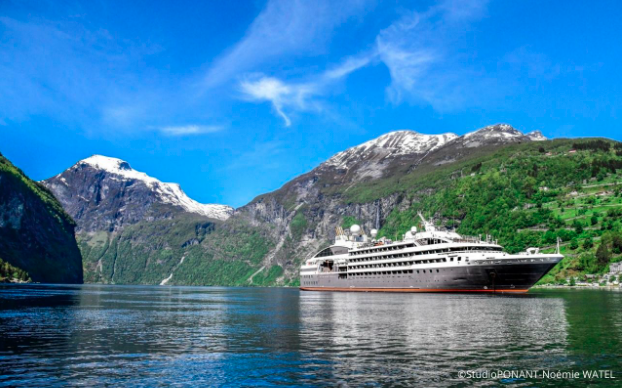 A Ponant cruise ship navigates the Norwegian fjords.