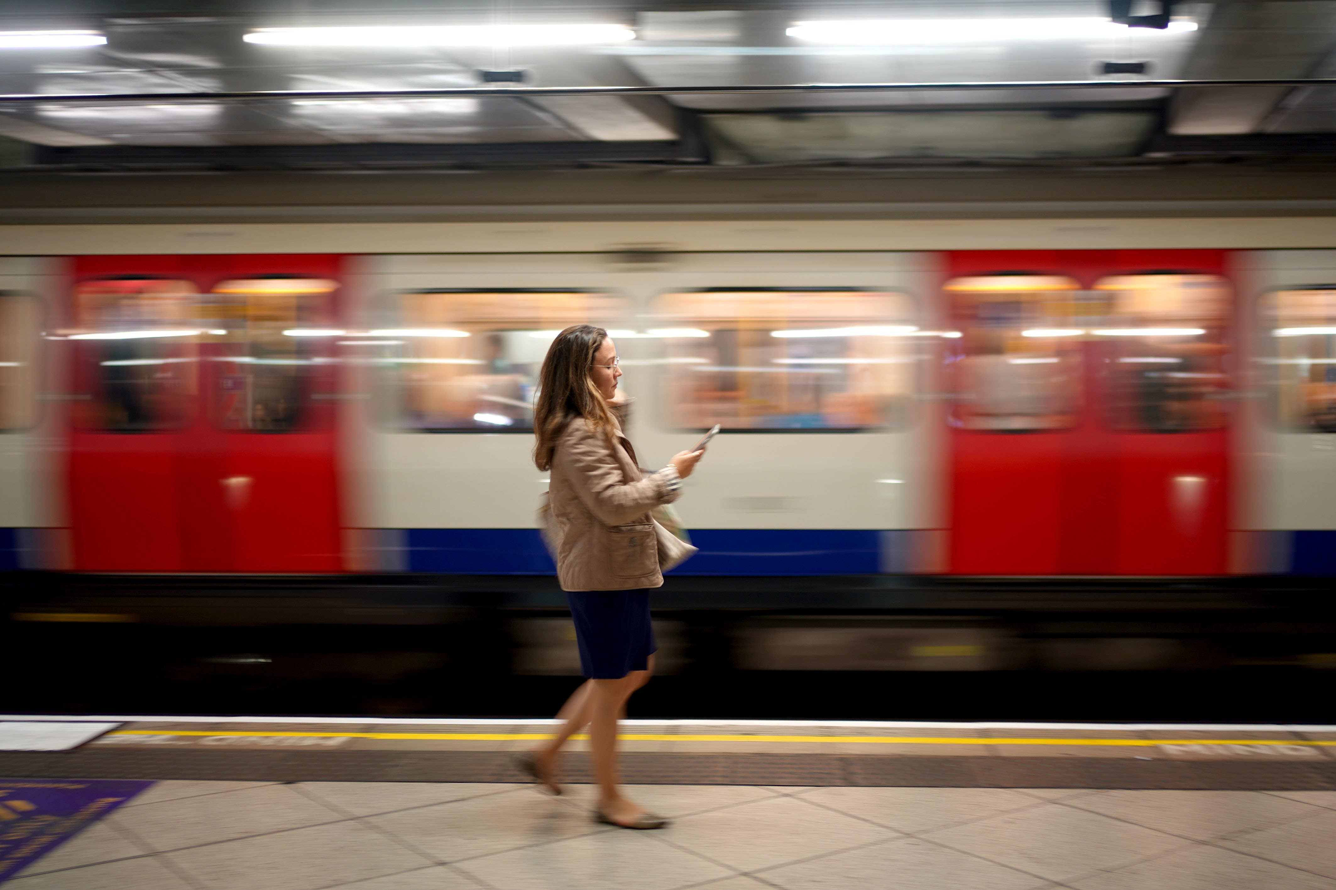 A woman waits at Westminster Station