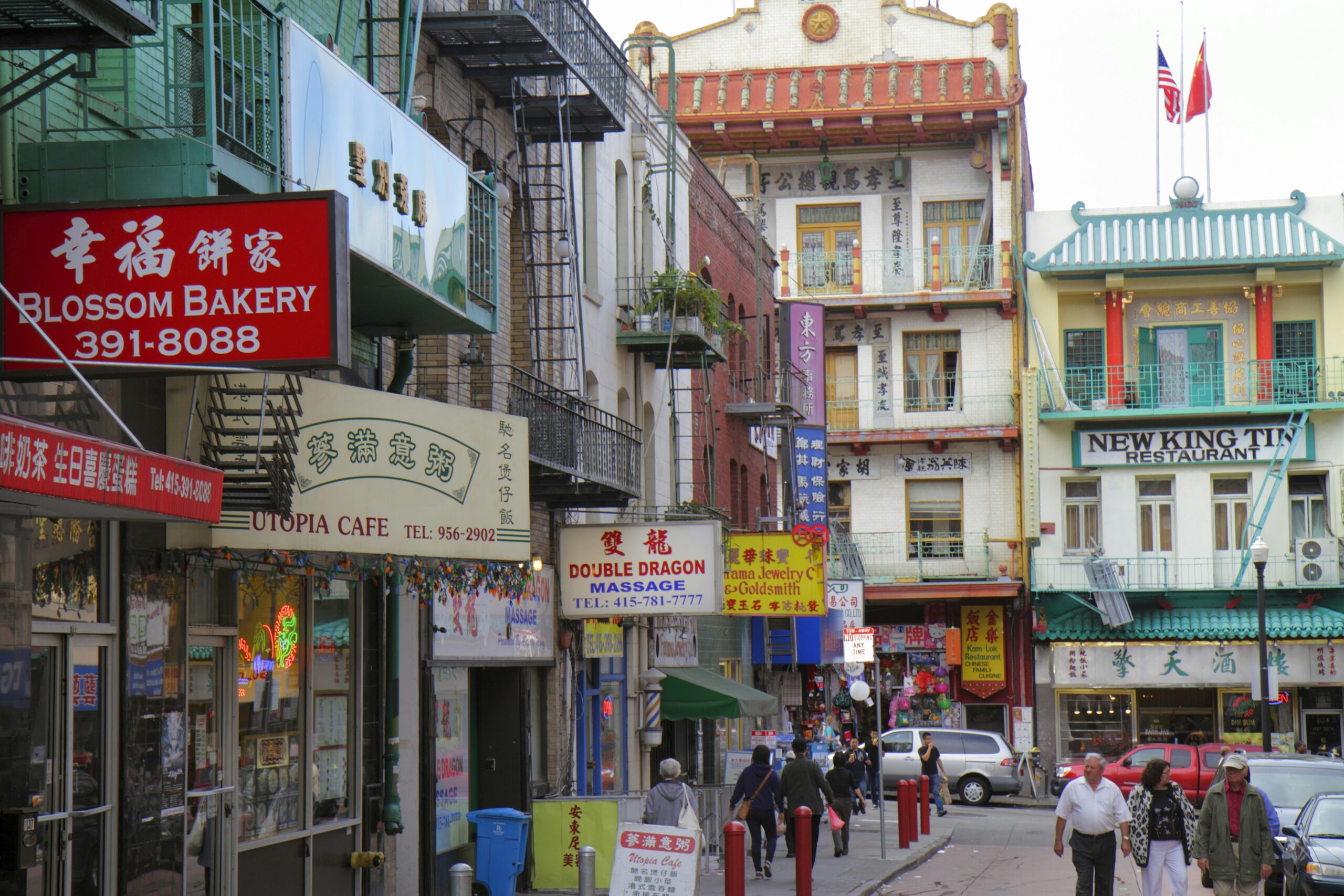 Colorful signs in English and Mandarin adorn the facades of buildings on Washington Street in Chinatown, San Francisco, California, USA