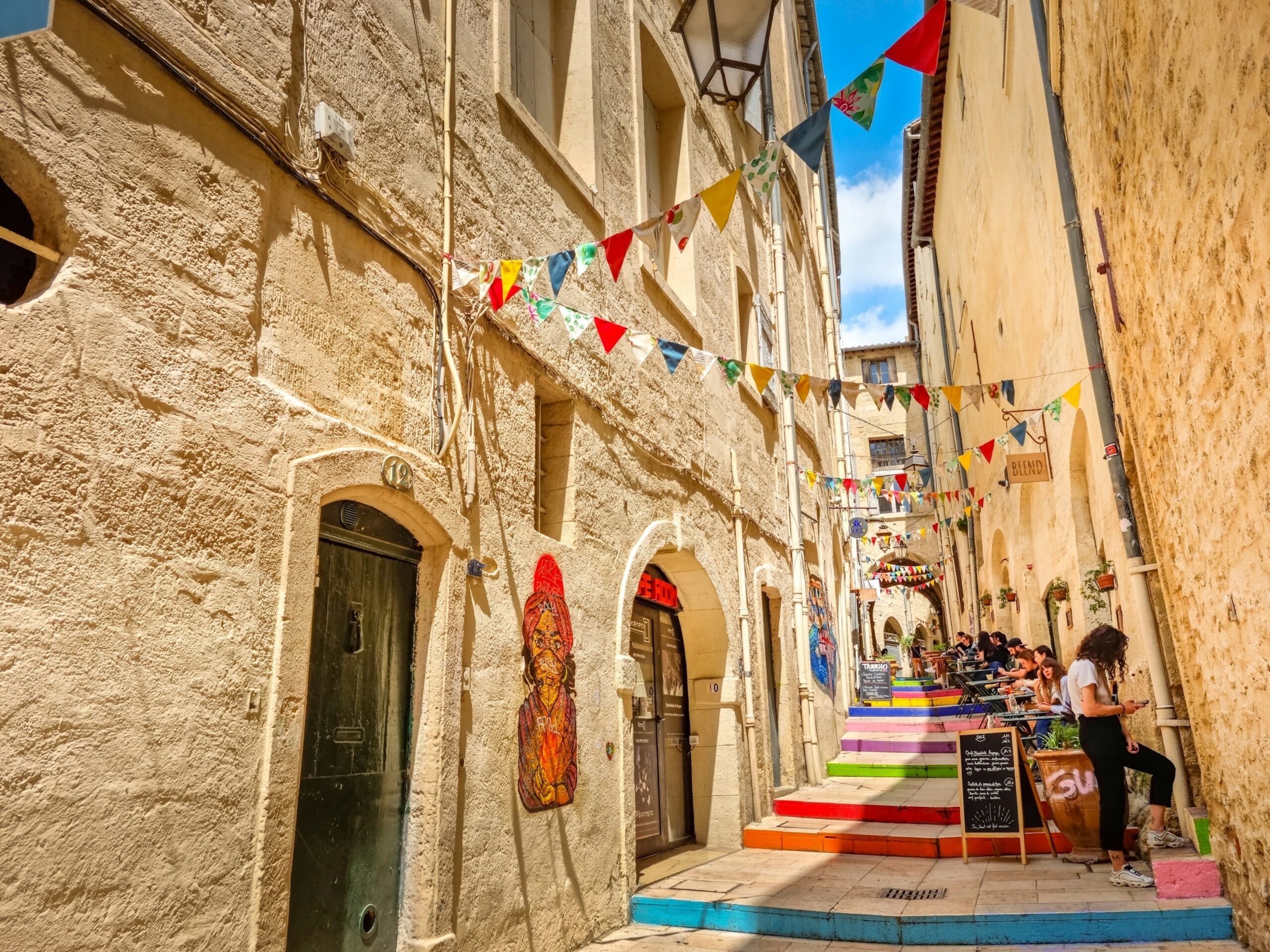 People walking down an alleyway in an old city centre