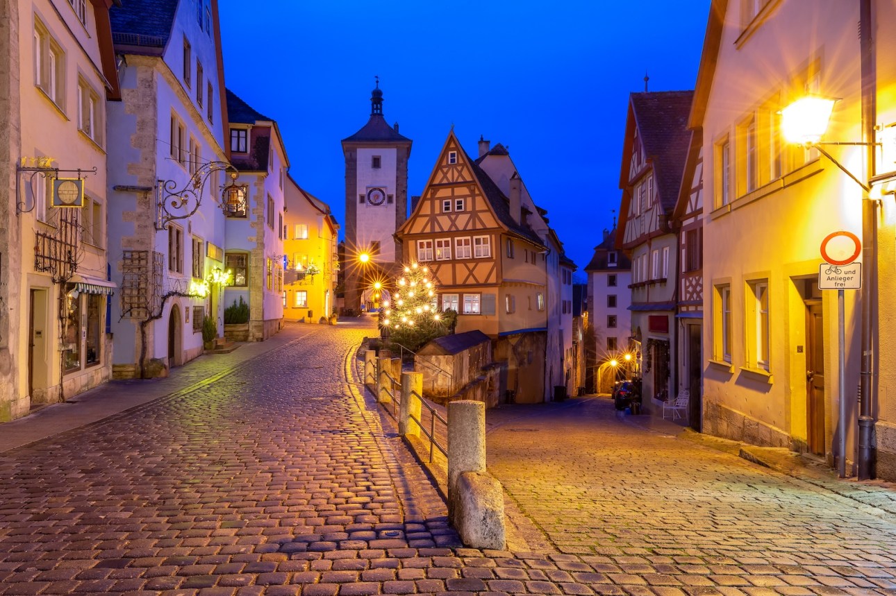 Decorated and illuminated Christmas street with gate and tower Plonlein in medieval Old Town of Rothenburg ob der Tauber, Bavaria, southern Germany