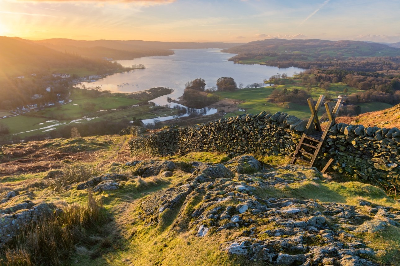 Lake Windermere in the English Lake District taken at sunrise with vibrant colours and golden morning light.