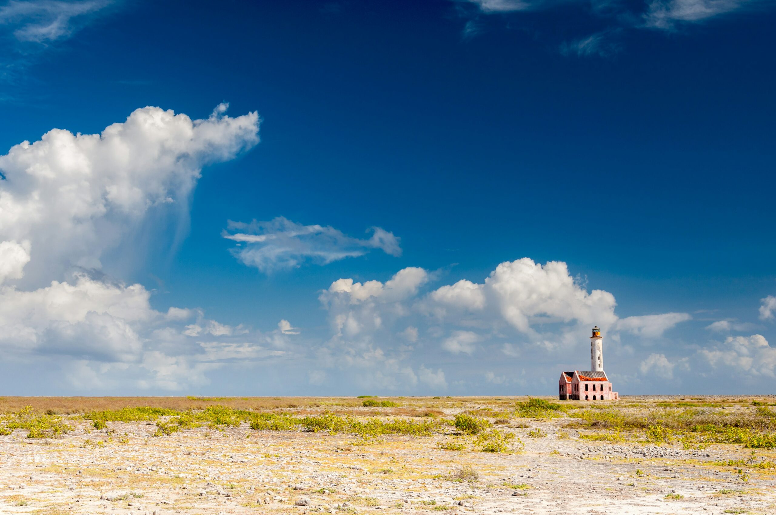 A lonely lighthouse on a desert-like island landscape