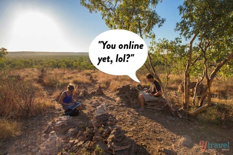 people using computers on a hiking trail