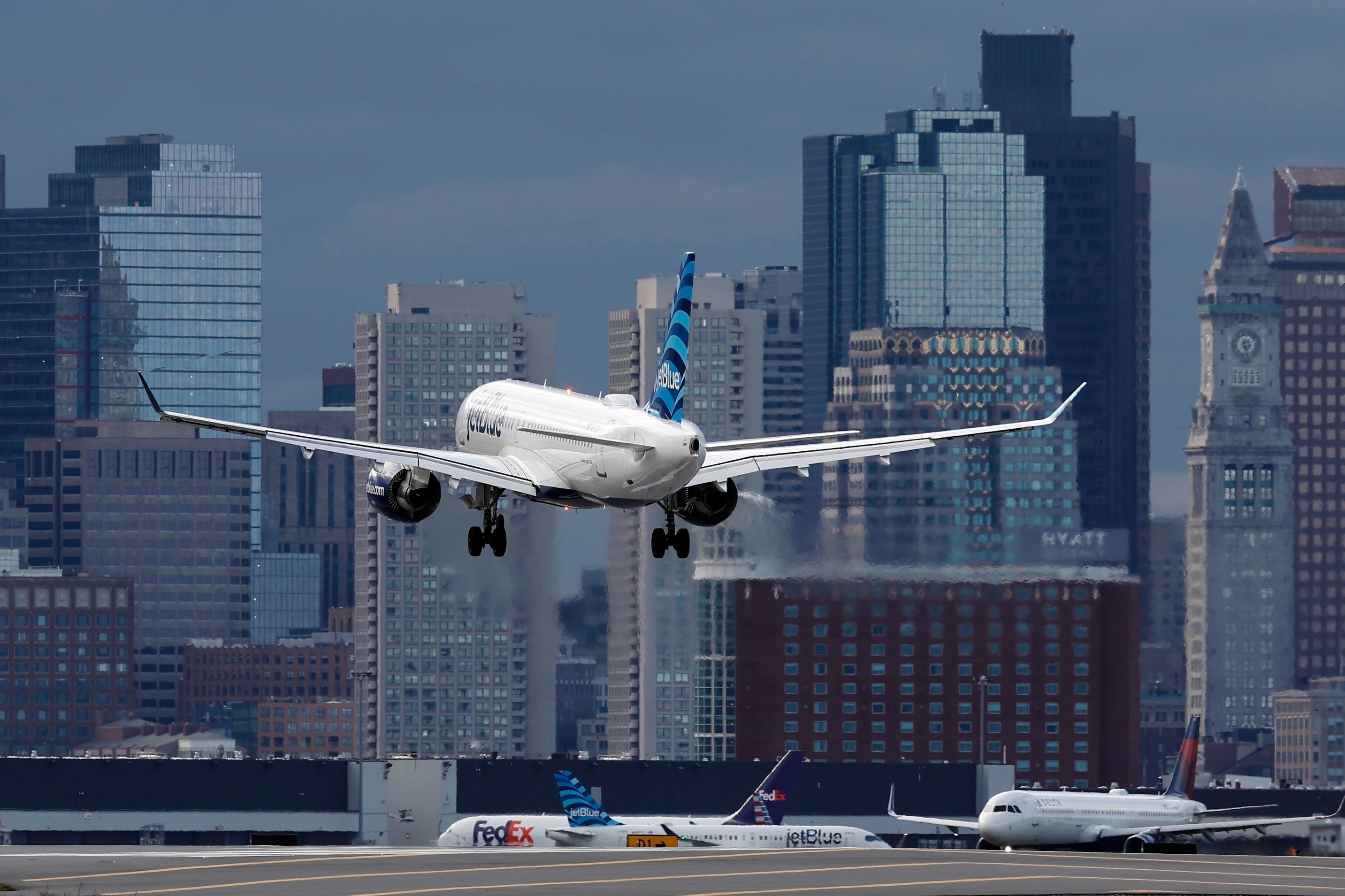 A JetBlue plane lands at Logan International Airport, Thursday, Jan. 26, 2023