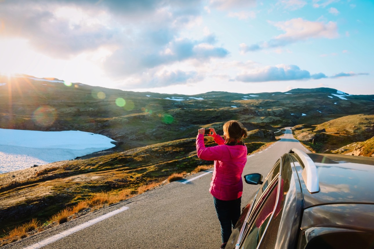 Traveler making photo of nature while travel by car