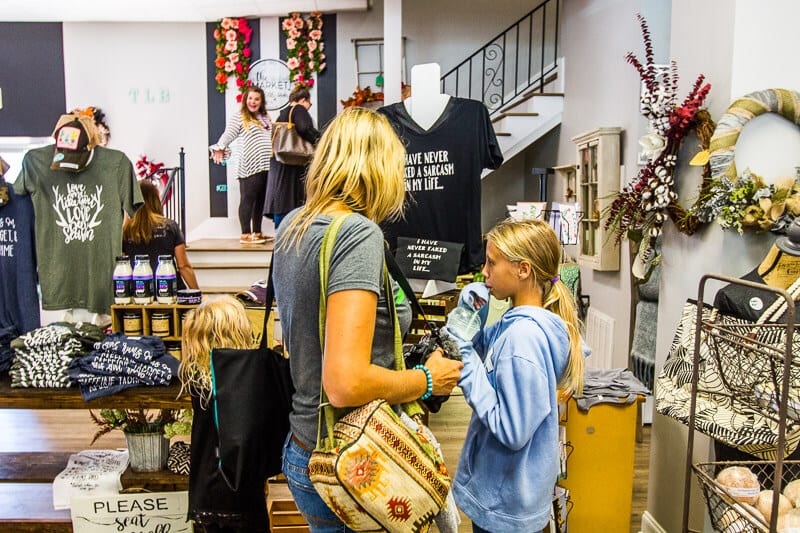 woman and children looking at displays in the The Market at Three Little Birds, 