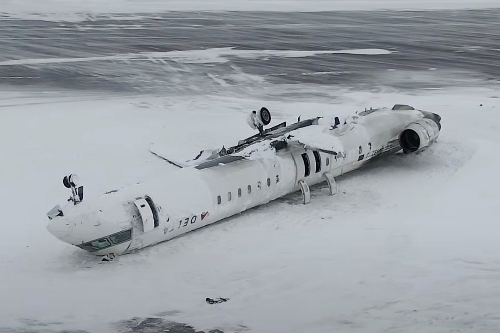This image taken from video released by the Transportation Safety Board of Canada shows the crashed plane at Toronto Pearson International Airport in Mississauga, Ontario
