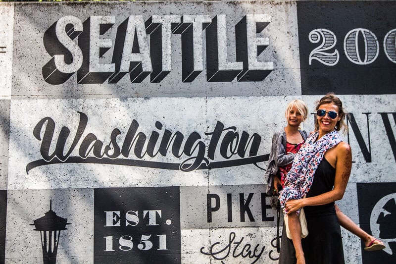people in front of a seattle mural