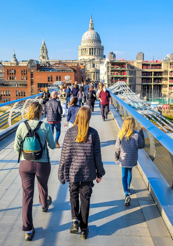 people crossing The Millennium Bridge, London, England