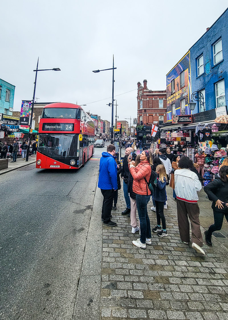 people standing on a city sidewalk