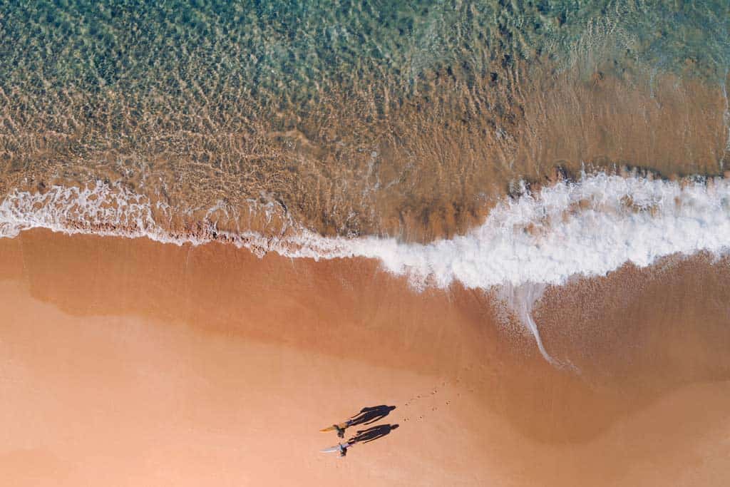 People Walking On The Beach In Australia