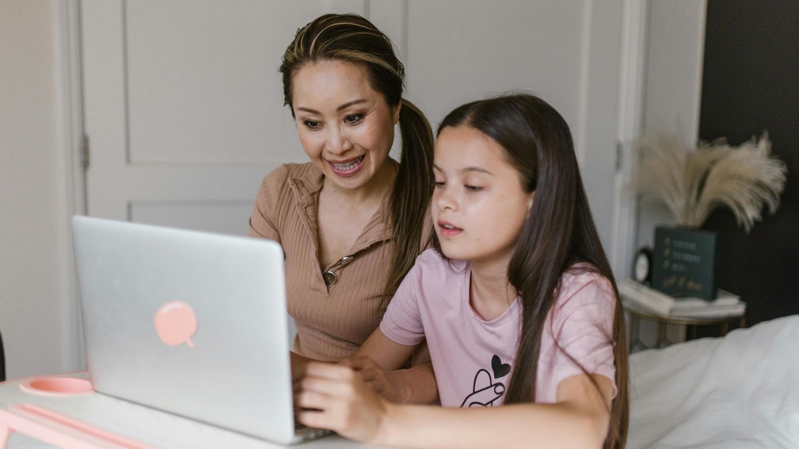 woman and kid learning using a laptop