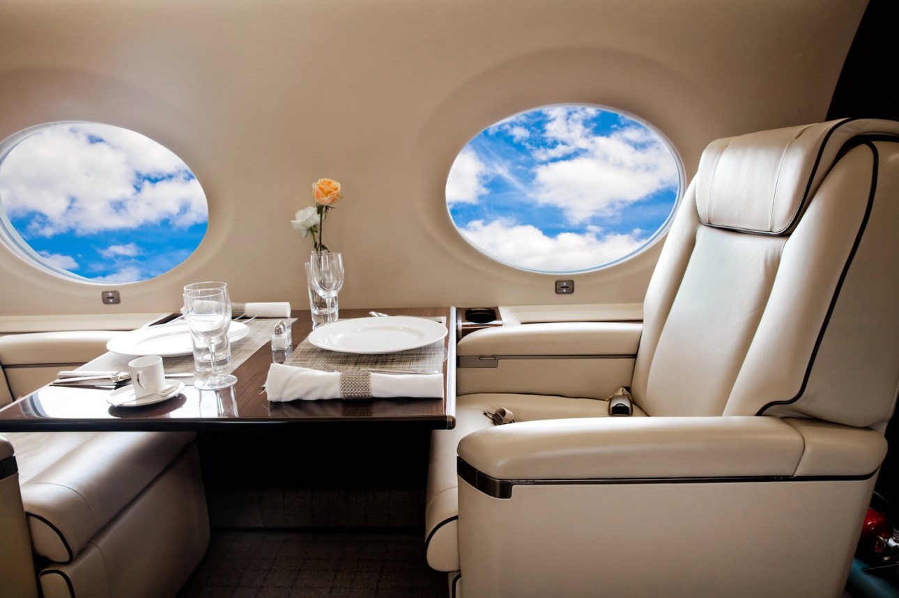 Clouds view in aircraft window, business jet flight