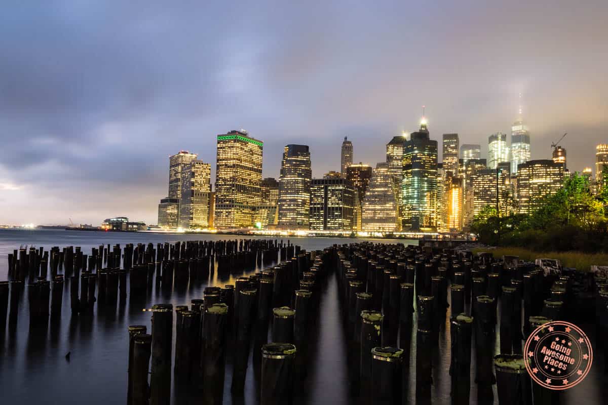 view of new york city buildings lit up from water