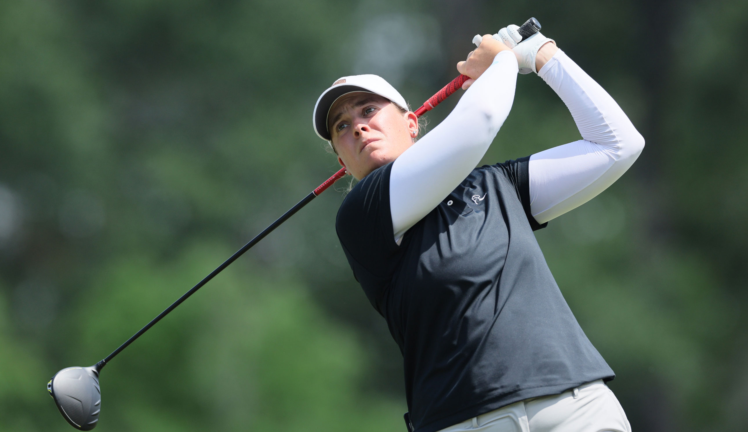 Lauren Coughlin hits a tee shot and watches its flight