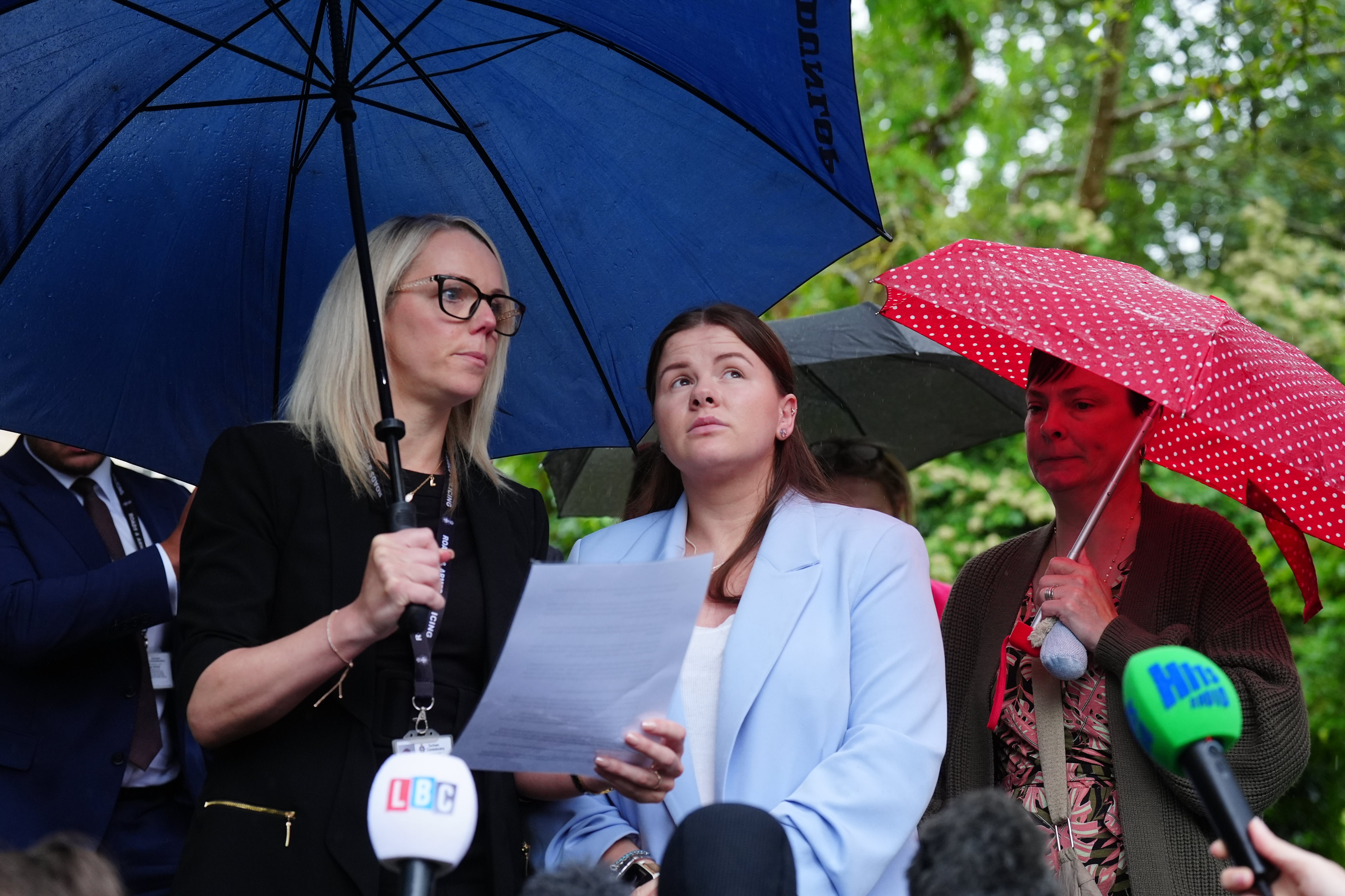 Detective Constable Natalie Horner, left, reads a statement to the media beside Sharlorna Warner, the mother of eight-month-old Zackary Blades