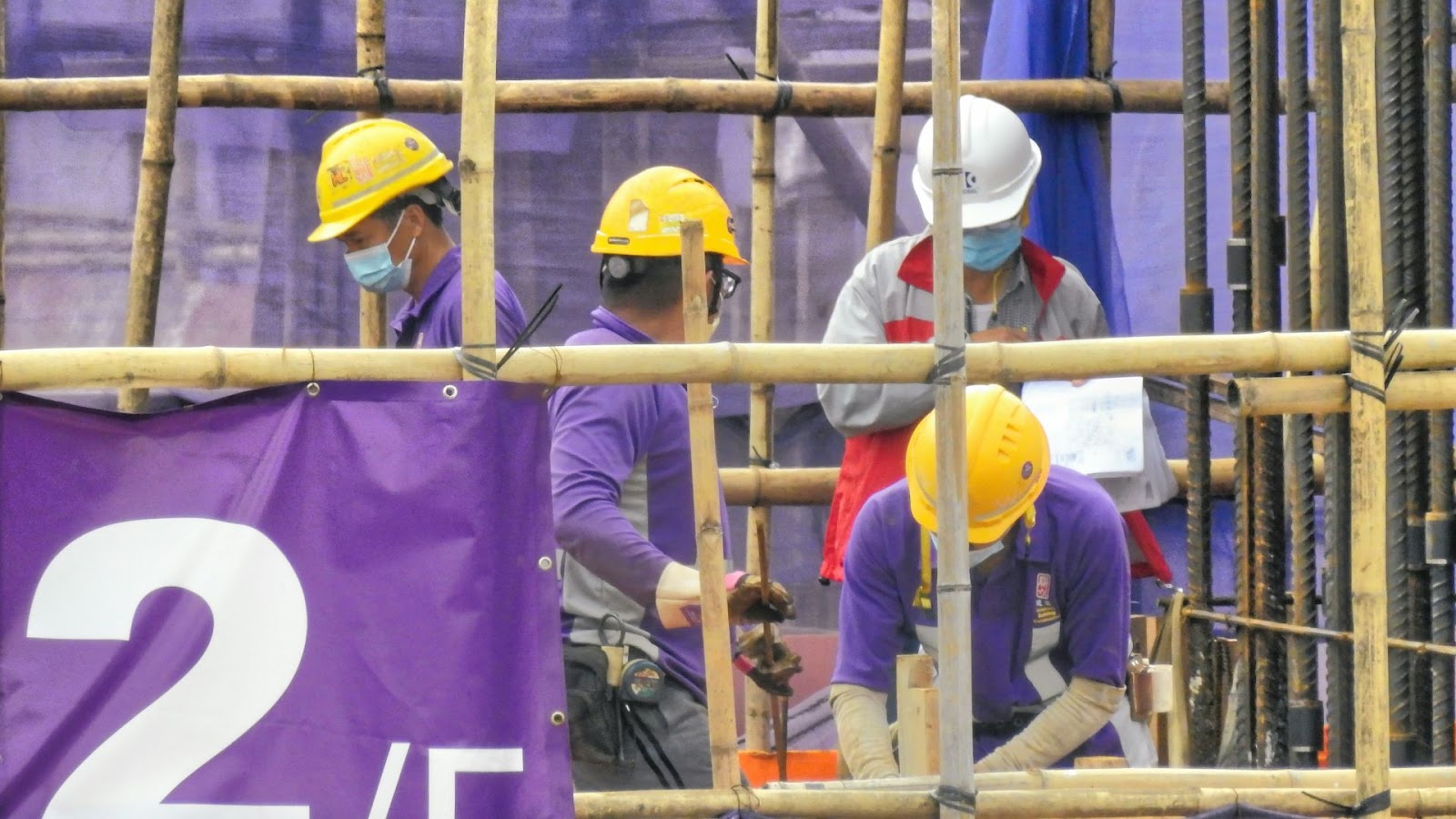 Four men doing construction work
