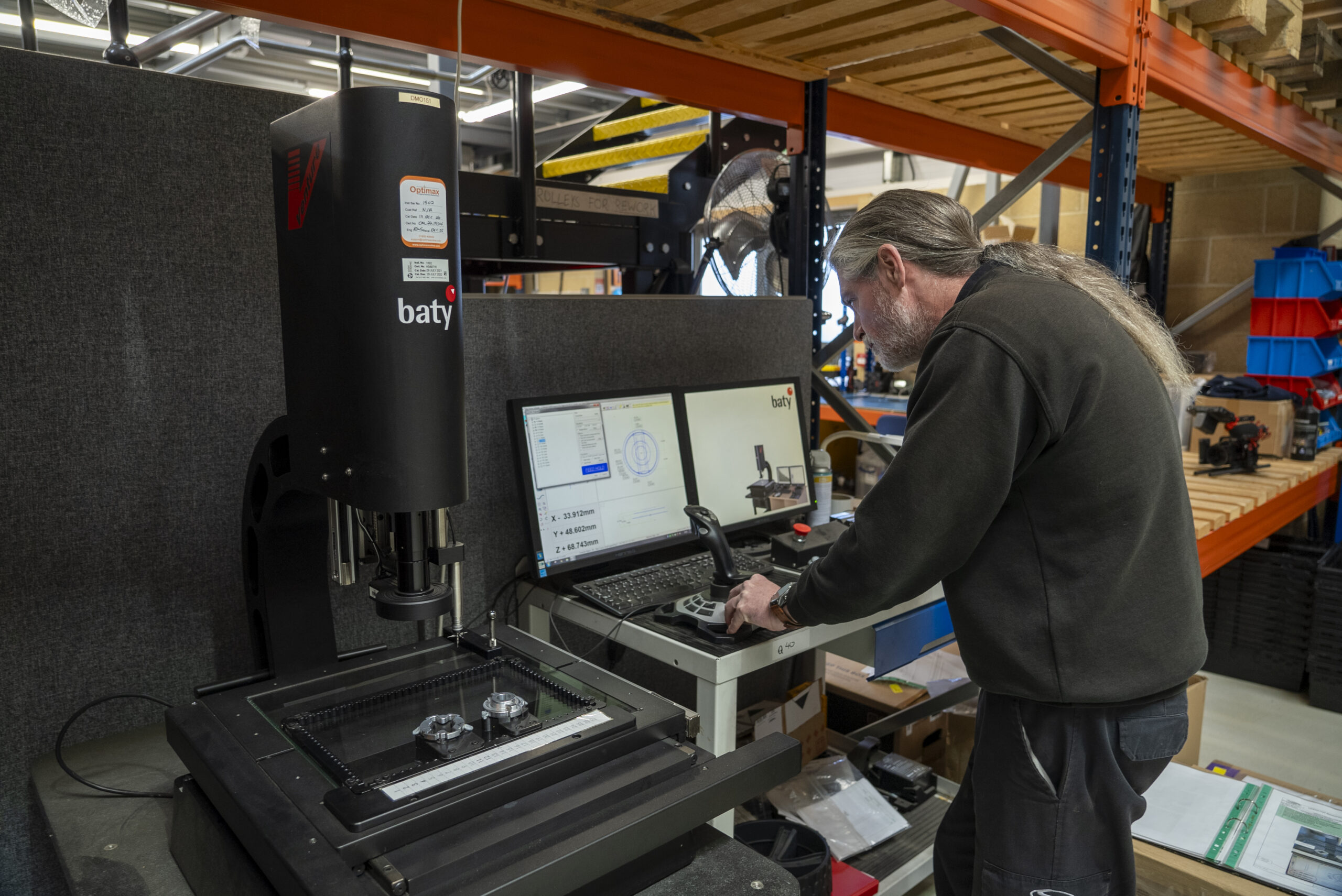 A Stewart Golf employee testing a part for precise measurements.