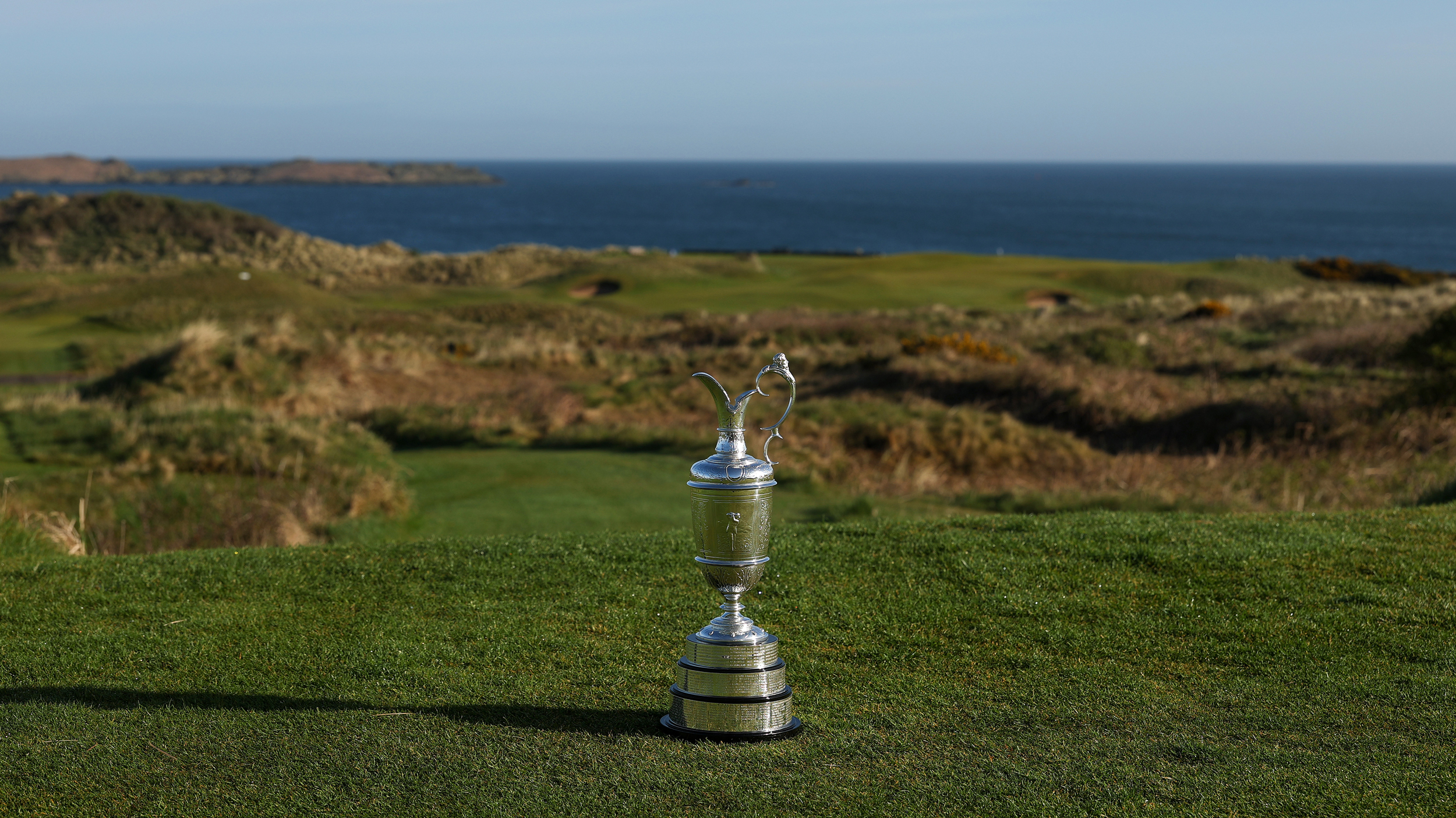 The Claret Jug stands in the foreground of Royal Portrush
