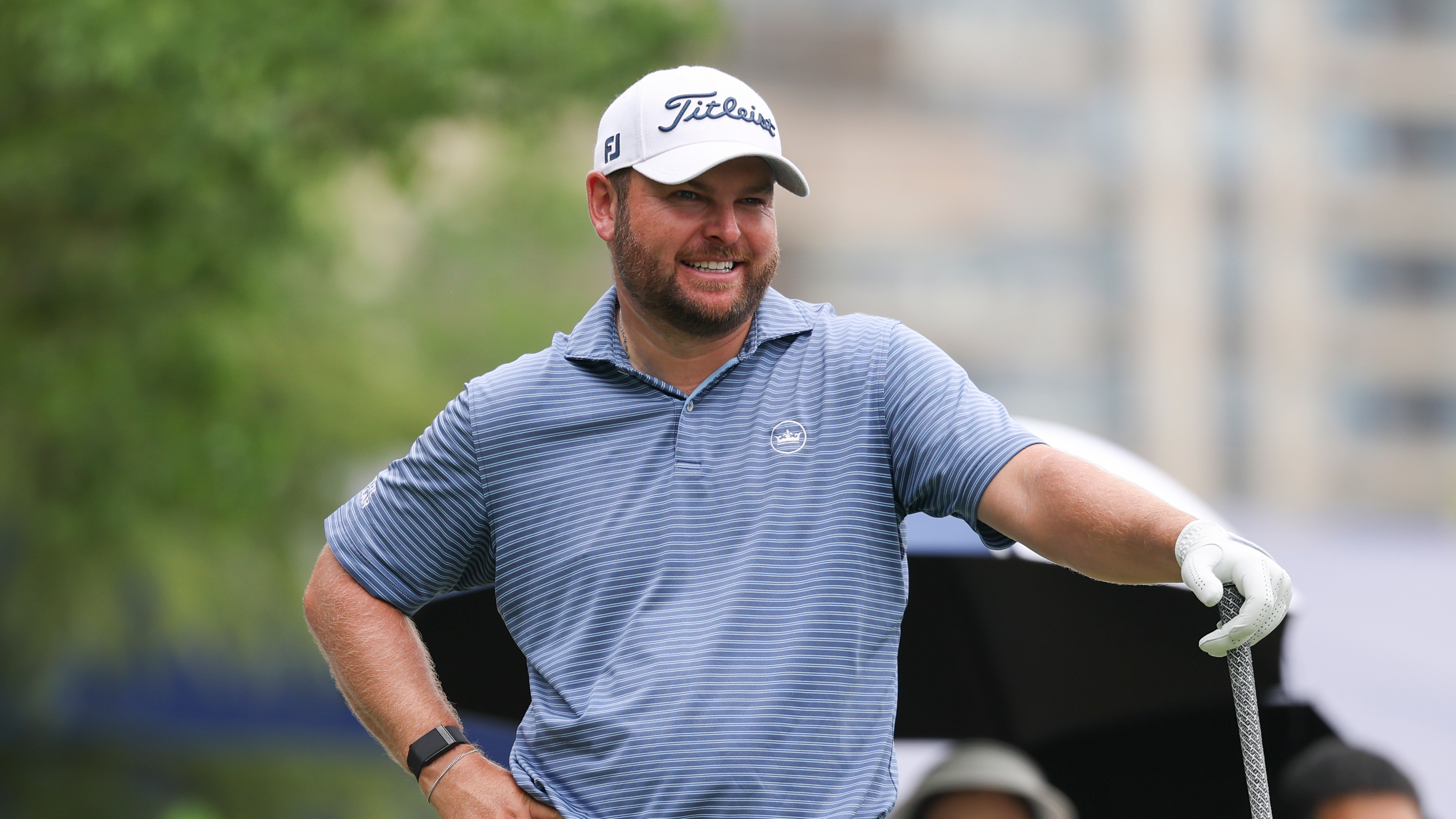 Jordan Smith smiles while placing his left hand on his driver at the 2025 China Open