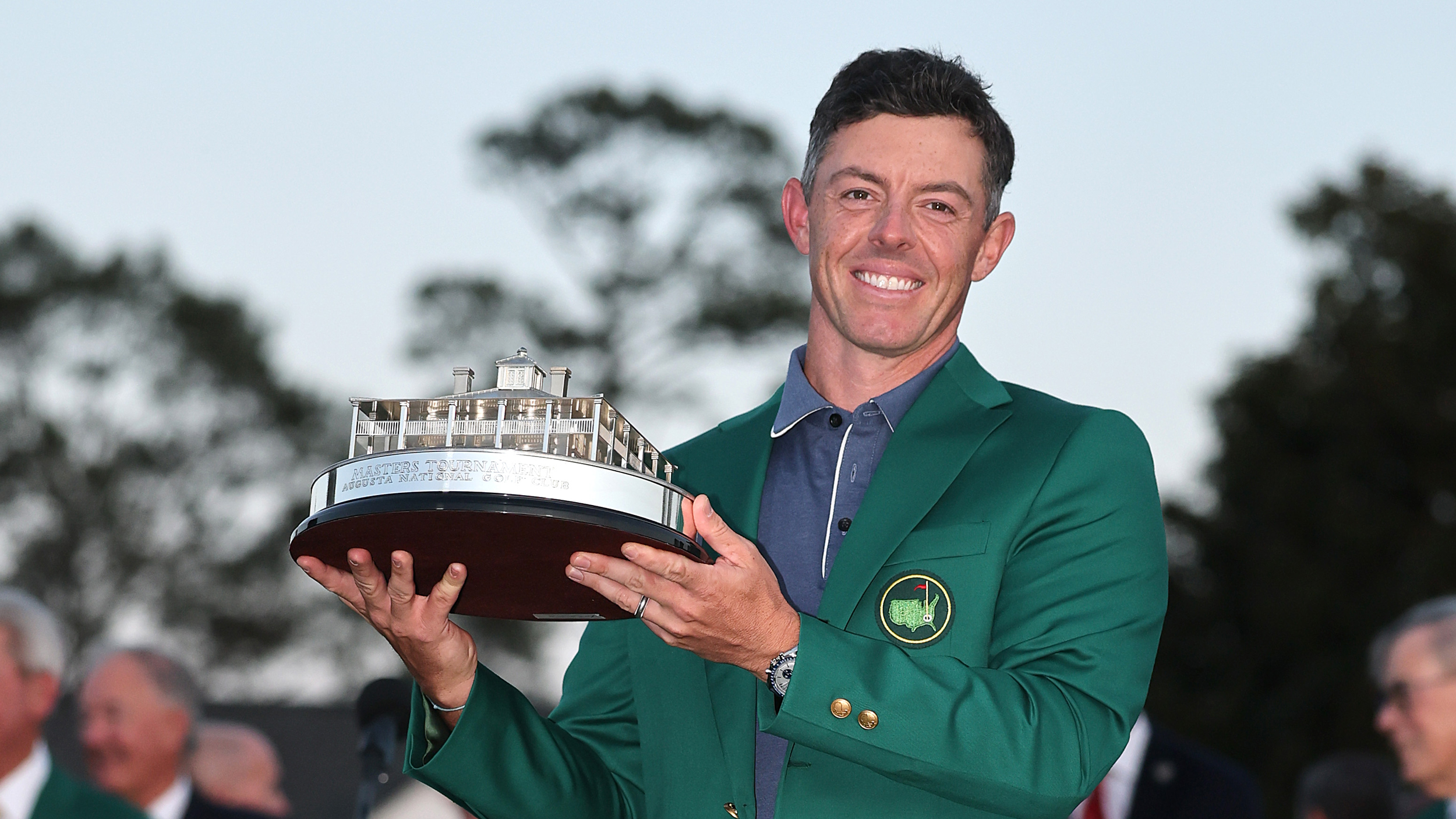 Rory McIlroy holding The Masters trophy while wearing the Green Jacket
