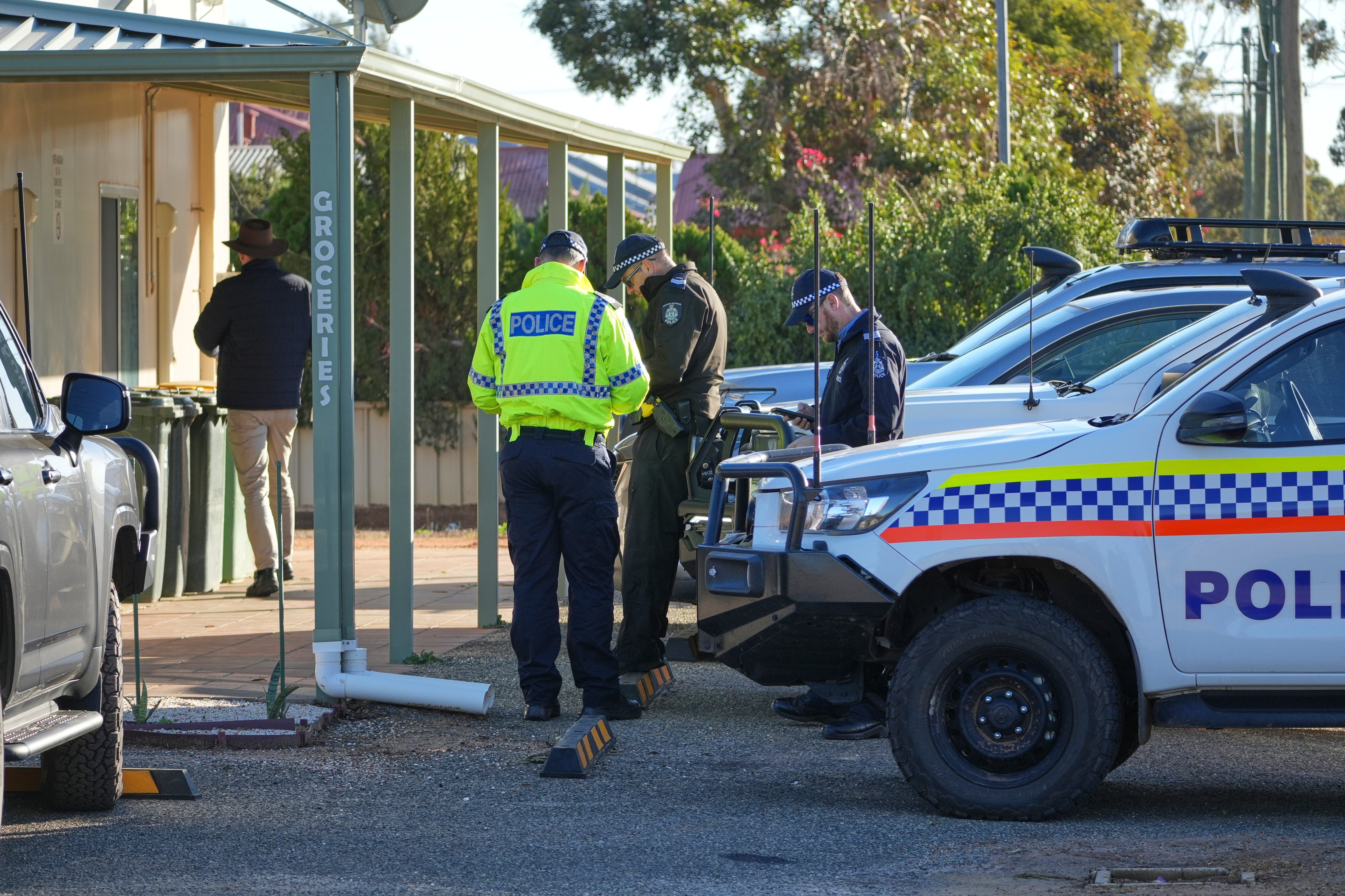 Police officers gather in Beacon, Western Australia, on Friday