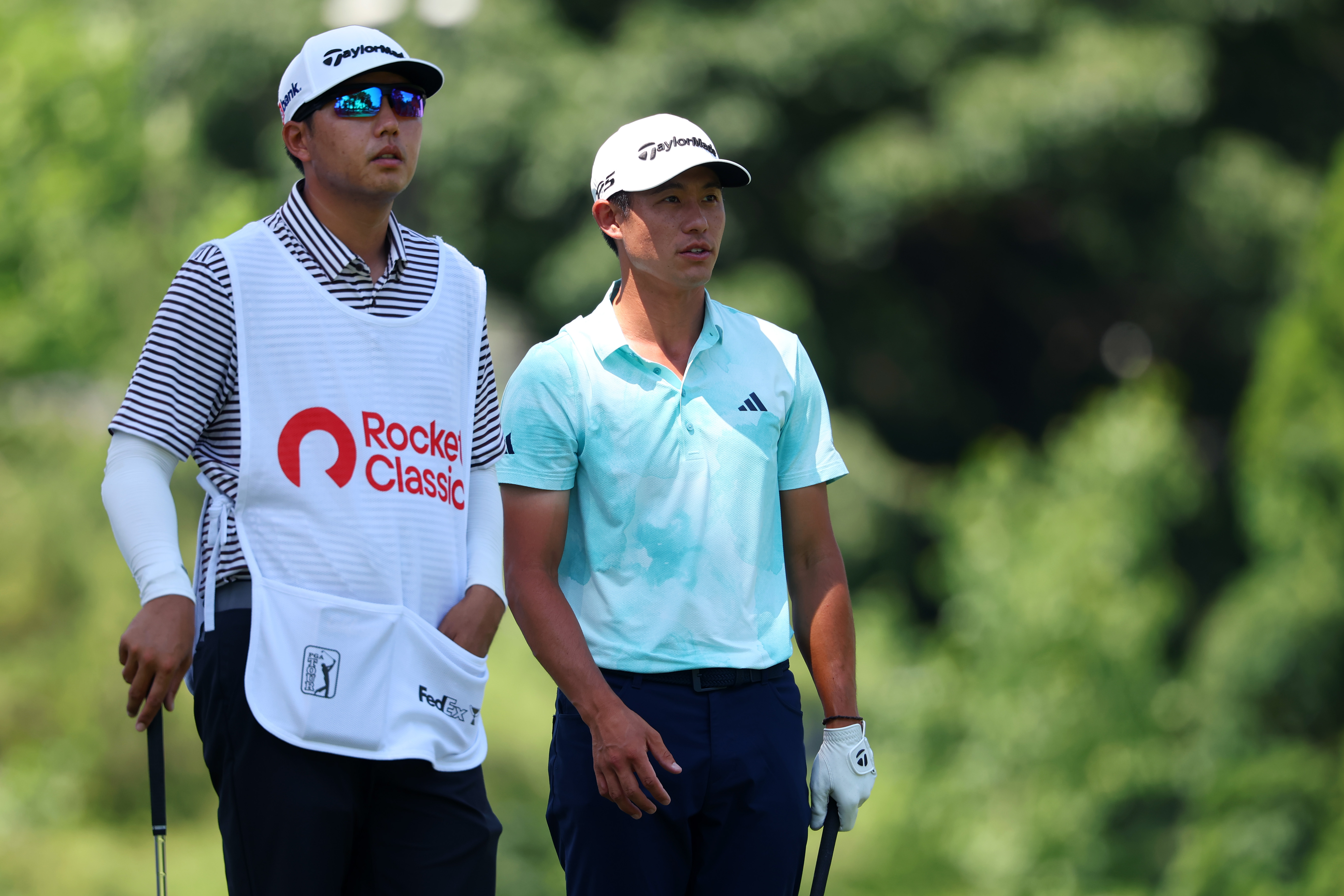 Collin Morikawa chats to his caddie