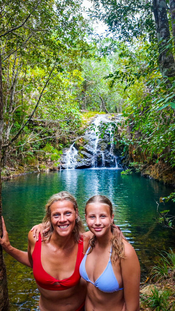 mother and daughter in front of private waterfall in belize