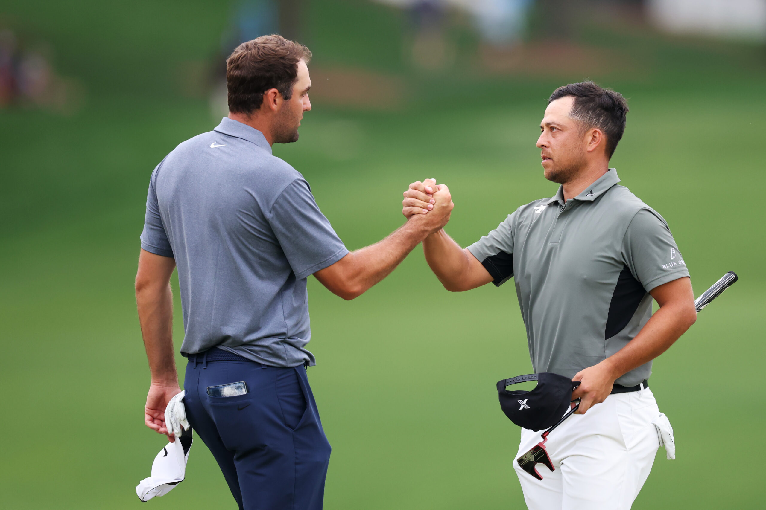 Scottie Scheffler and Xander Schauffele shake hands