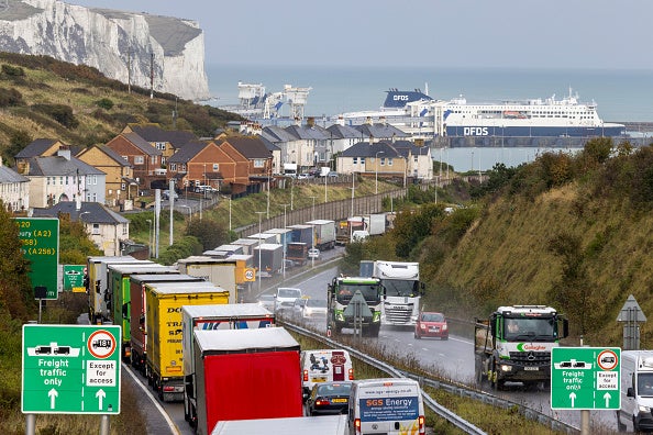 Lorries line up on the A20 road to use the Dover Tap contraflow system into the Eastern Dock of the Port of Dover where the cross channel port is situated with ferries departing here to go to Calais in France