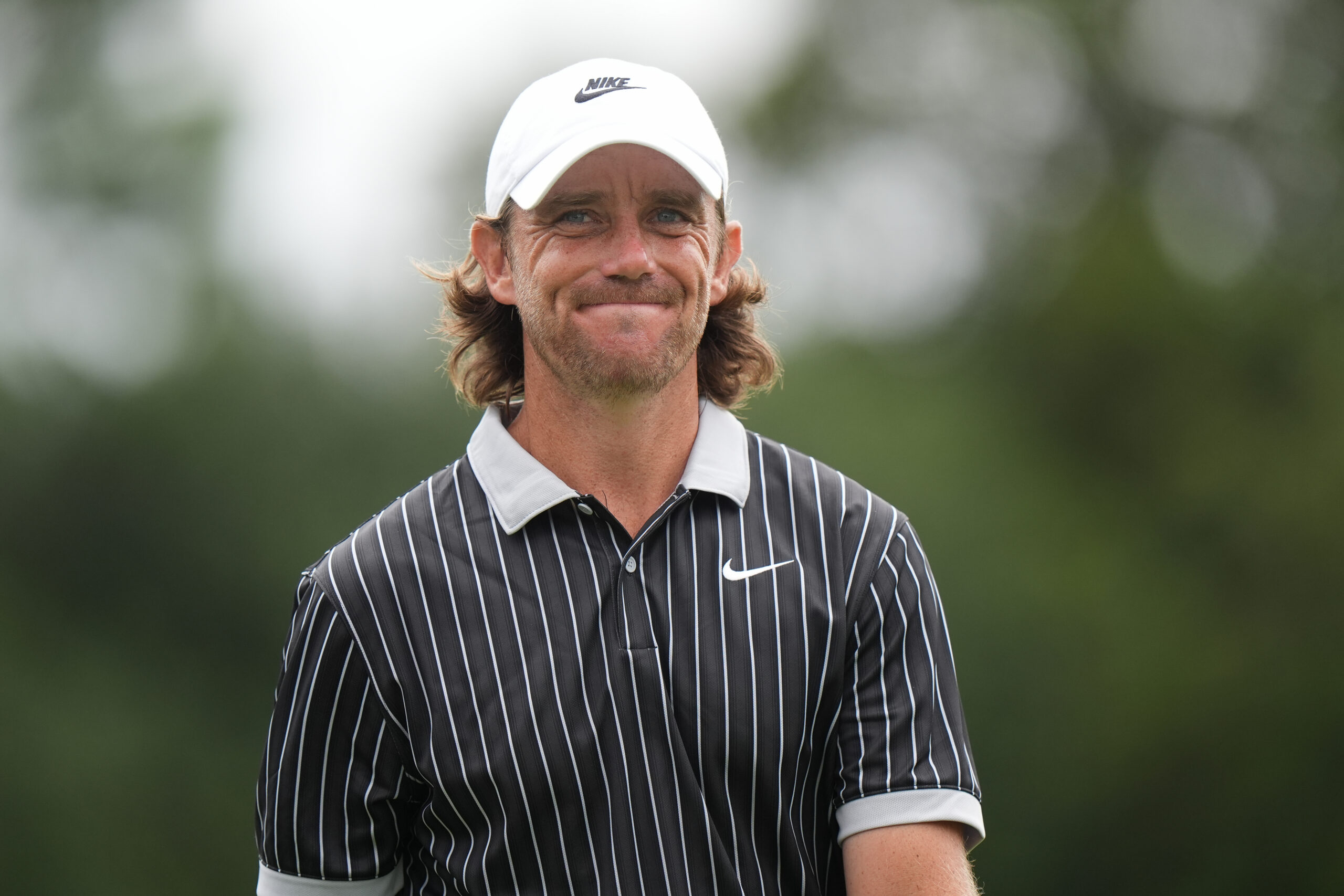 Tommy Fleetwood smiles as he walks off the green