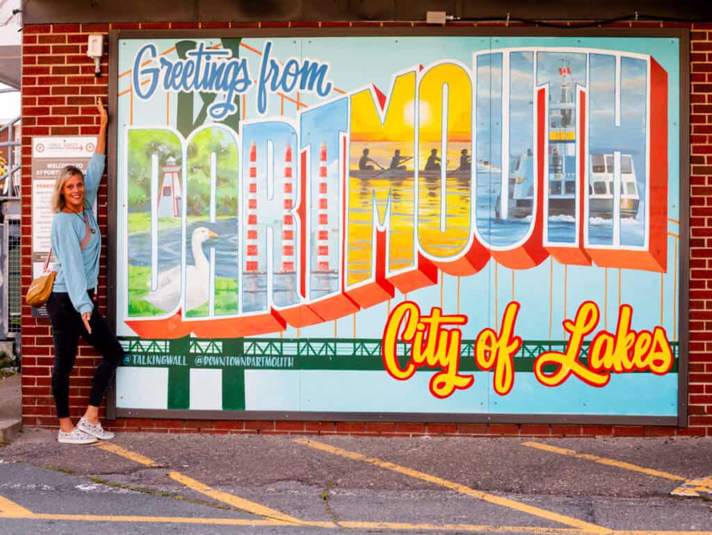 woman beside dartmouth mural